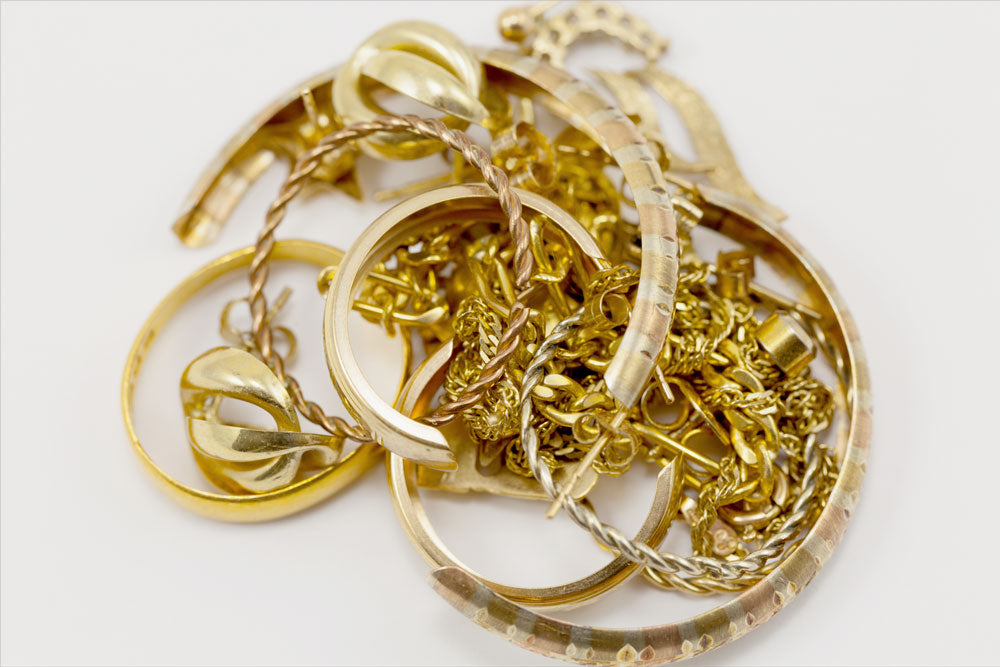 Scarp Gold jewelry including necklaces and rings on a white background. Sell your old gold online near me